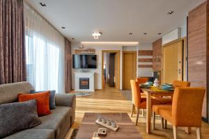 a living room with a couch and a table at Apartman Thalia Kalman in Zlatibor