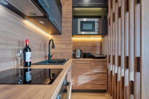 a kitchen with a sink and a microwave at Apartman Thalia Kalman in Zlatibor