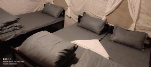 2 camas individuales en una tienda con almohadas en The Jungle Mist Resort en Rishīkesh