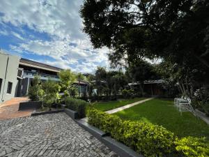 a garden with a stone walkway in front of a building at Marion Lodge in Johannesburg