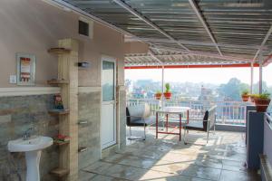 a balcony with a sink and a table at Lotus Apartment in Pokhara
