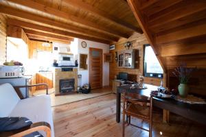 a kitchen and dining room with wooden walls and wooden floors at Janówka in Łomża