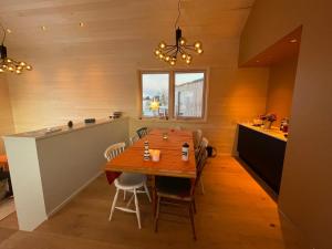 comedor con mesa y cocina en Superior Cabin with Private Beach Lofoten, 