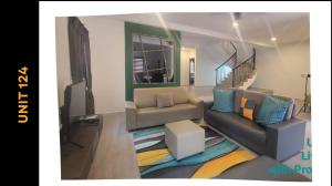 a living room with a couch and a table at Ipoh Family Villa-Spacious Stay for 21 or 42Pax in Ipoh +55 photos