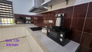 a kitchen with a coffee maker on a counter at Ipoh Family Villa-Spacious Stay for 21 or 42Pax in Ipoh