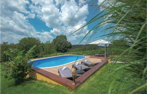 a swimming pool with chaise lounge chairs next to it at Lovely Home In Varazdinske Toplice in Varaždinske Toplice