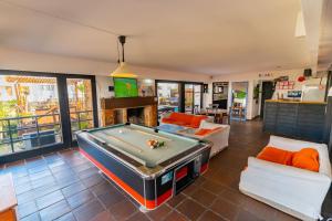 a living room with a pool table at Hostel 32 in Punta del Este