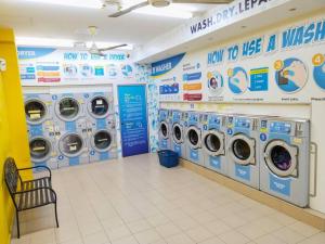 a laundry room with washing machines in a store at 575 Port Dickson # U Homestay - 2KM to Beach & Free Wifi in Port Dickson +39 photos