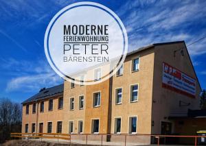 a building with a sign that reads moderne performing peer bartering at Großzügige Fewo Peter in Bärenstein in Bärenstein