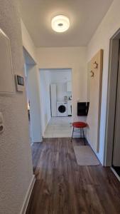 a living room with a red chair and a kitchen at Großzügige Fewo Peter in Bärenstein in Bärenstein