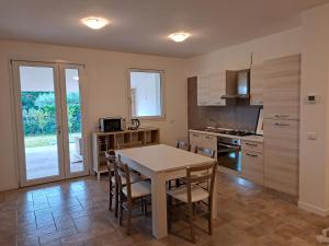 a kitchen with a table and chairs in a room at Casa sul Conca in San Giovanni in Marignano