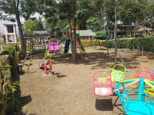 a playground with colorful playground equipment in a yard at Triple Eden Resort - Naivasha in Naivasha