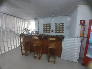 a room with a bar in the middle of a building at Hotel Habibi in Barranquilla