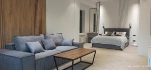 a living room with a couch and a bed at Centrado Apartments in Tashkent