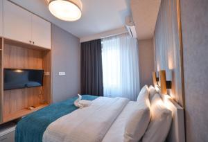 En eller flere senge i et værelse på Hotel Babi