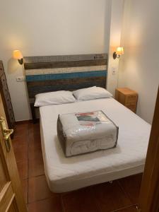 a bedroom with a large bed with a white bedspread at Apartamento Plaza Pradollano 1 in Sierra Nevada