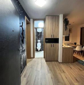 a room with a hallway with a kitchen and a door at Mons Apartments Jahorina in Jahorina