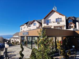 a building with a christmas tree in front of it at Milmari Resort P41 in Kopaonik