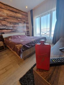 a bedroom with a bed with a wooden wall at Milmari Resort P41 in Kopaonik +51 photos