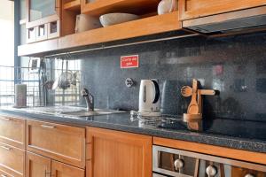 a kitchen with a sink and a counter top at Levada dos Piornais, a Home in Madeira in Funchal