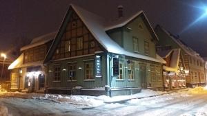 a house on a snowy street at night at Studio Apartment in Pärnu