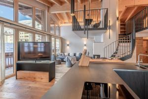 a living room with a large couch and a tv at Weinleinshof Appartements in Vent