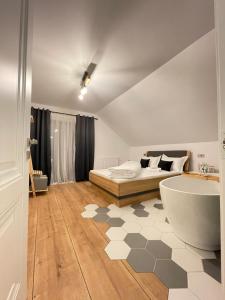 a bathroom with a bed and a tub in a room at Hill House SD in Topliţa