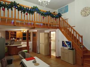 a kitchen and a living room with a staircase at Bogate Studio in Żywiec