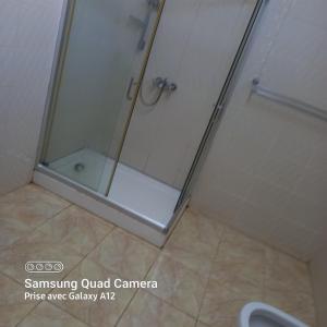 a shower with a glass door in a bathroom at Chez mimi 2 in Mahébourg +17 photos