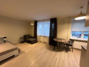 a bedroom with a bed and a table and a desk at Beautiful Apartment Great Location FREE PARKING in Rīga
