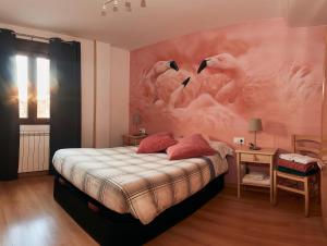 a bedroom with a large painting of flamingos on the wall at Apartamento Alcázar parking incluido VU-TERUEL-18-035 in Teruel