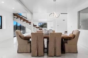 a dining room with a wooden table and chairs at New Pure Lux Retreat W Private Pool/Spa Near Beach in Ardmore