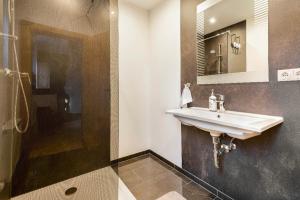 a bathroom with a sink and a shower at The Dolomiti View in Debant