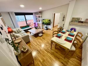 a living room with a table and chairs at A FIGUEIRIÑA 8 in Vigo