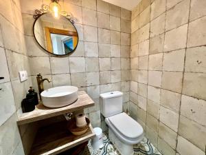 a bathroom with a sink and a toilet and a mirror at VilaVigo in Vigo +16 photos