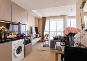 a kitchen and living room with a washer and dryer at The Panora Pattaya in Pattaya South