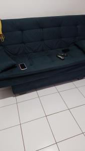 ein schwarzes Bett auf einem weißen Boden in der Unterkunft Apartamento Salvador in Salvador