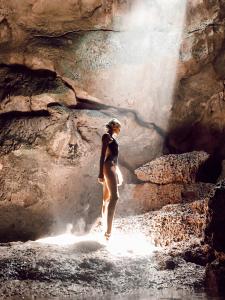 a person standing in the water in a waterfall at Blue Moon Inn in Dauis