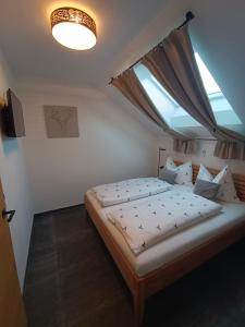 a bedroom with a large bed with a window at Murperle in Sankt Michael im Lungau
