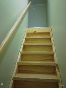 a stair case with wooden stairs in a room at Apartamento por dia in Puerto Montt