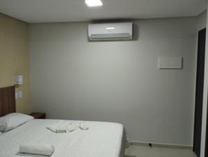 a bedroom with a bed with two towels on it at Pousada Casarão do Porto - Porto de Galinhas PE in Porto De Galinhas