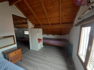 a small room with a refrigerator and a bed in it at Alquiler temporario en Necochea in Necochea