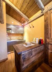 a kitchen with a wooden counter top in a room at La Buca delle Fate in Gressan