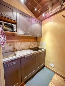 a kitchen with stainless steel cabinets and a sink at La Buca delle Fate in Gressan