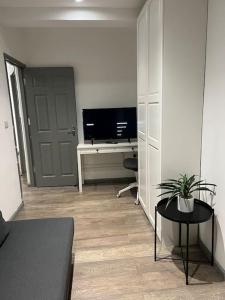a living room with a television and a desk with a table at 1 Bedroom flat in Euston! 4 person. in London