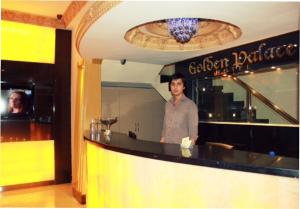 a man standing at a bar in a restaurant at GOLDEN PALACE in Kuala Lumpur