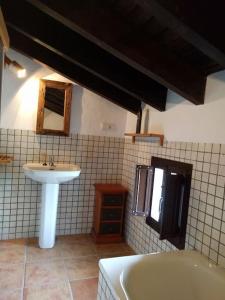 a bathroom with a sink and a bath tub at CASA HUGANA in Benalup Casas Viejas