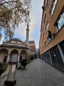 an empty street in a city with a mosque at REMSA in Sarajevo