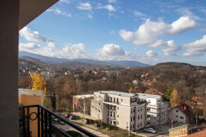 a view of a city from the balcony of a building at Apartman 442 in Vrnjačka Banja