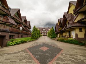 an empty street in a town with houses at VisitZakopane - Crocus Apartment in Zakopane